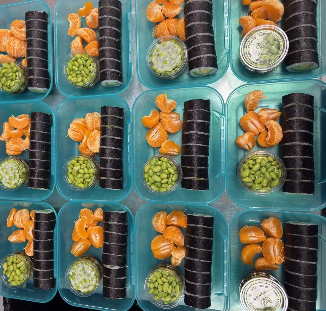 Avocado cucumber roll bento with edamame and tangerines